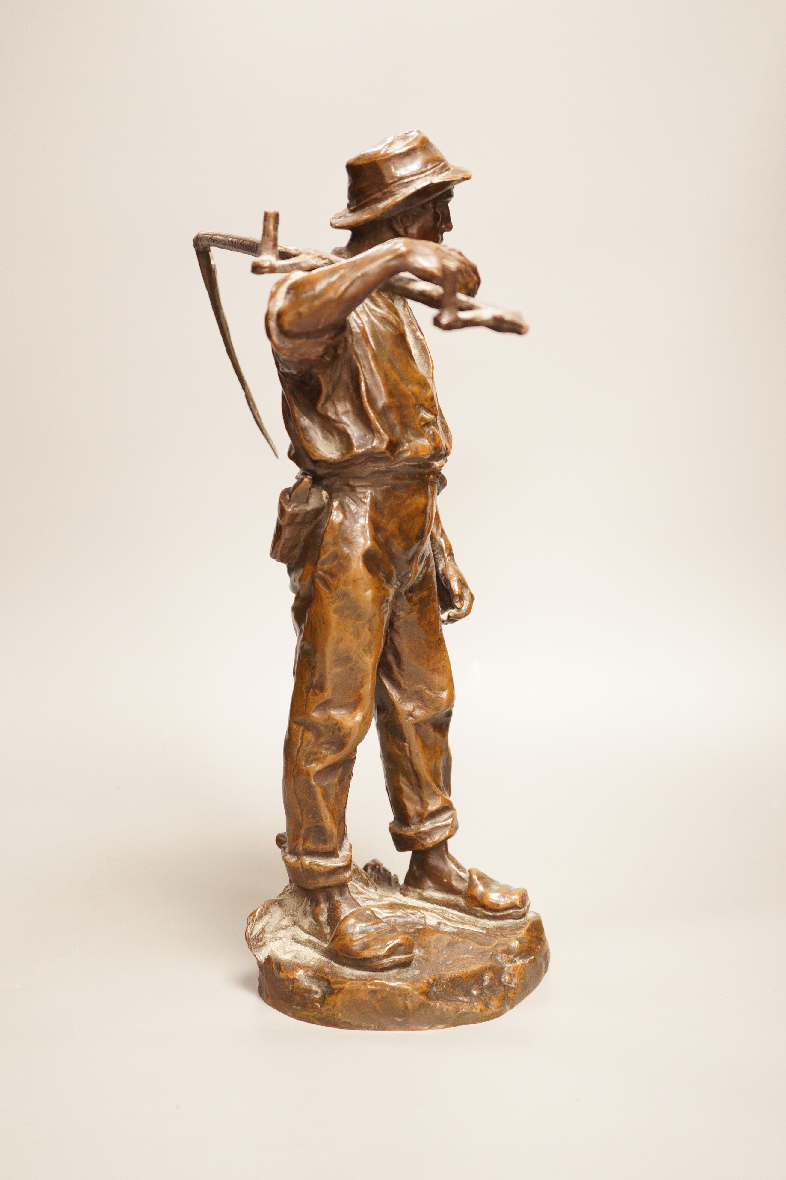 Hans Muller (Austrian, 1837-1937) a bronze group of a farmhand with scythe, signed to base, 39cm tall